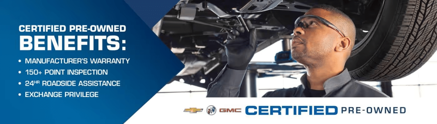 A technician inspecting the underside of a vehicle as part of a certified pre-owned program, highlighting benefits such as manufacturer’s warranty, 150+ point inspection, 24-hour roadside assistance, and exchange privilege for Chevrolet and GMC vehicles.