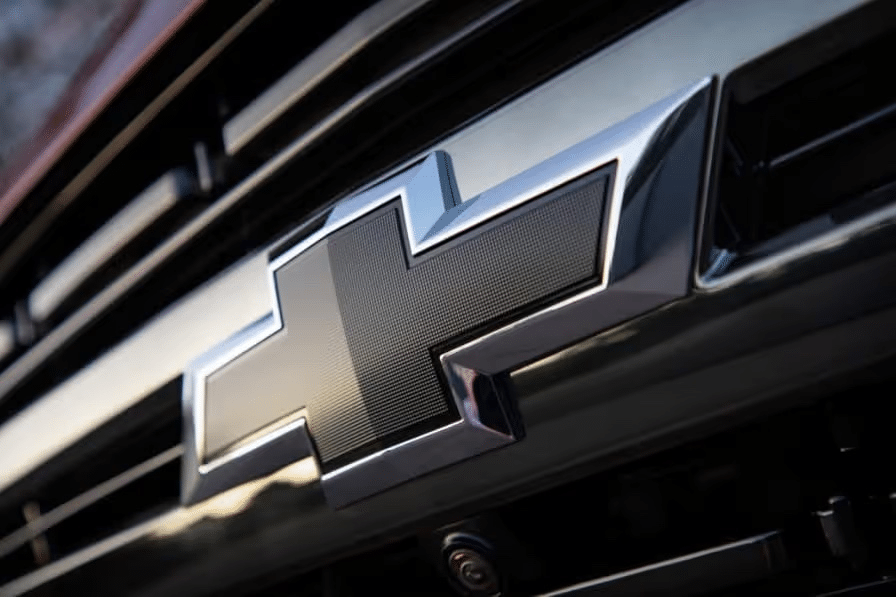 Close-up image of the Chevrolet logo prominently displayed on a vehicle's grille, showcasing its iconic design and chrome accents.