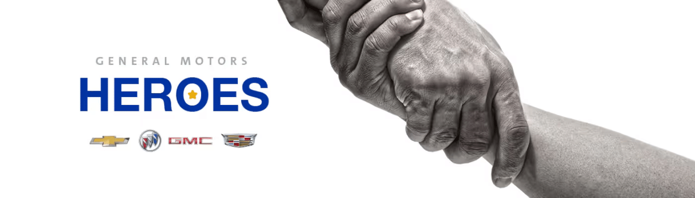 General Motors "Heroes" campaign image featuring diverse hands clasped together, symbolizing unity and support. Accompanied by the GM brand logos: Chevrolet, Buick, GMC, and Cadillac.