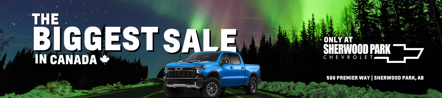 Blue Chevrolet truck on a road under a vibrant northern lights display, promoting the biggest sale in Canada at Sherwood Park Chevrolet located at 500 Premier Way, Sherwood Park, AB.
