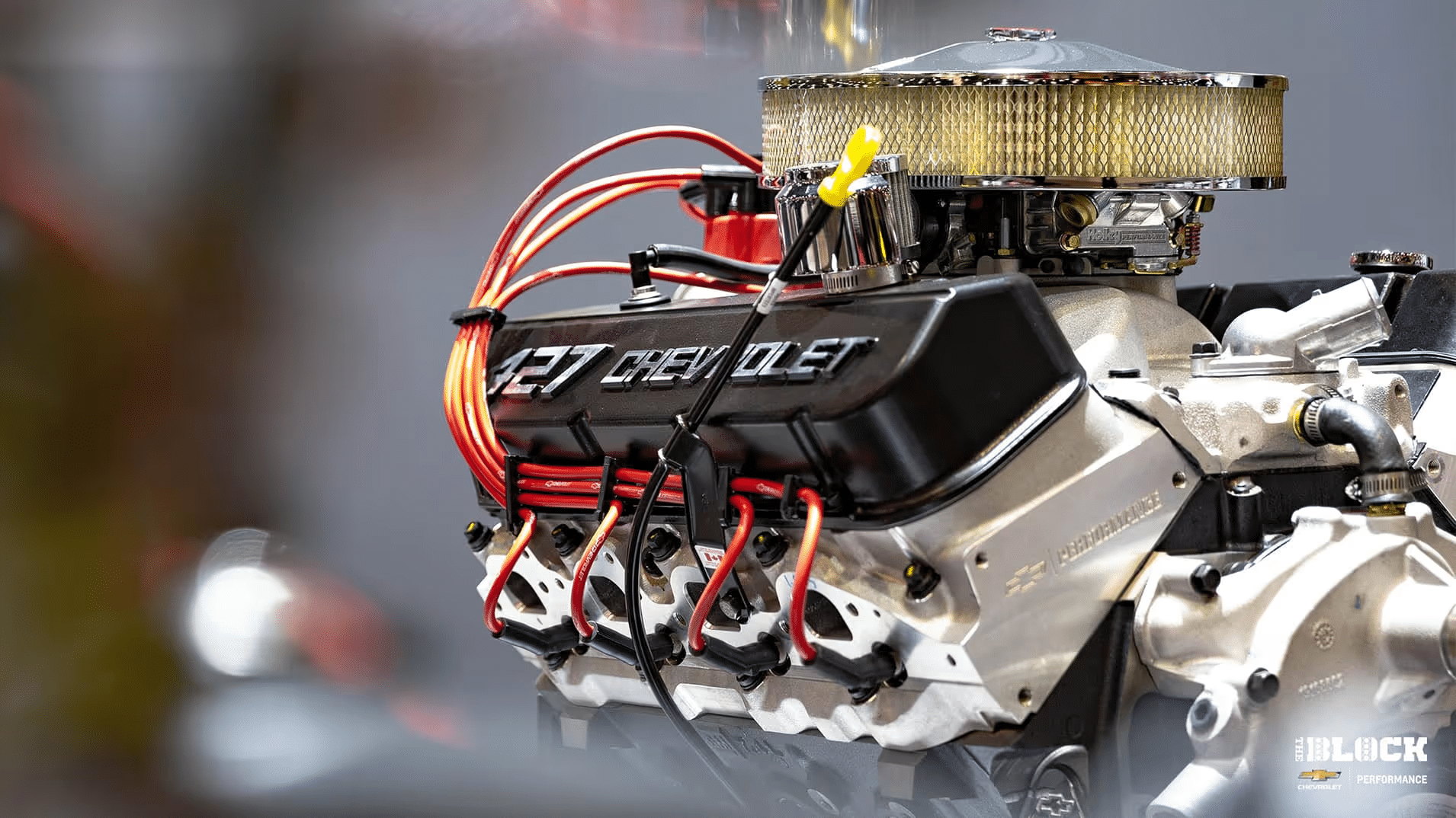 Engine compartment featuring a turbocharged LTR engine with a distinctive red and black valve cover, showcasing high-performance components and sleek design. Ideal for automotive enthusiasts and performance car builders.