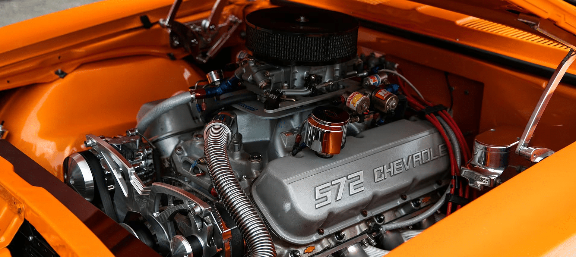 Close-up view of a high-performance engine with a supercharger, showcasing intricate details like the air intake system and engine components, highlighting automotive engineering and performance tuning.