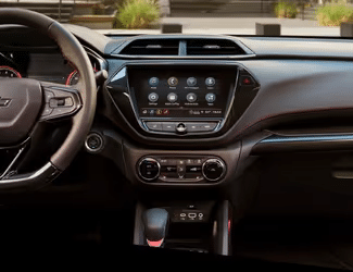 Modern car interior featuring a sleek dashboard with a touchscreen display, intuitive controls, and a stylish gear shift. The layout emphasizes user-friendly technology and contemporary design elements, ideal for enhancing the driving experience.
