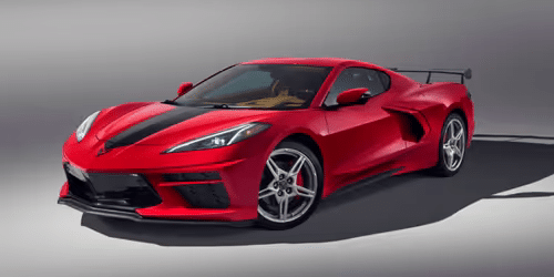 Red Chevrolet Corvette C8 with a black racing stripe and aerodynamic features, showcasing its sporty design and performance capabilities.
