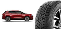 Gray alloy car wheel with five spokes next to a black tire with traction grooves.