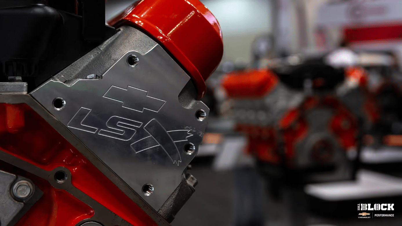 Close-up view of a high-performance engine with a supercharger, showcasing intricate details like the air intake system and engine components, highlighting automotive engineering and performance tuning.