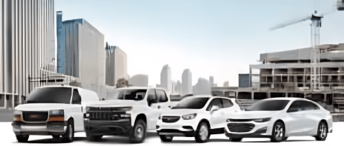 A lineup of four diverse vehicles displayed in an urban setting, including a van, a pickup truck, a compact SUV, and a sedan, with a city skyline and construction site in the background.