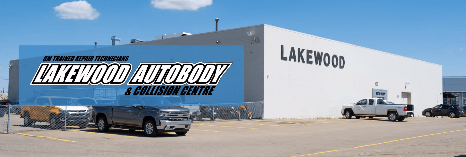 Exterior view of Lakewood Autobody and Collision Centre featuring a range of parked vehicles, including trucks and cars, alongside a modern building prominently displaying the Lakewood name. The image highlights the facility's focus on GM-trained repair technicians and collision services.
