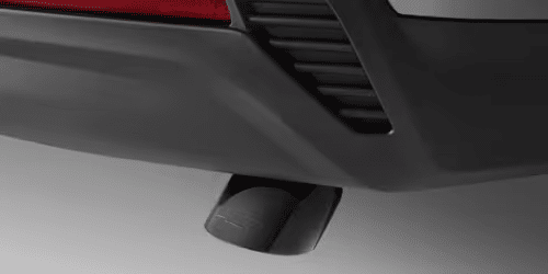 Close-up view of a car's exhaust tip, showcasing a sleek design integrated into the rear bumper, highlighting automotive performance and style.
