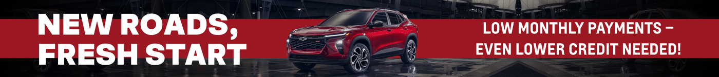 Red Chevrolet SUV displayed in a modern showroom with promotional text highlighting low monthly payments and accessible financing options, emphasizing a fresh start for potential buyers.